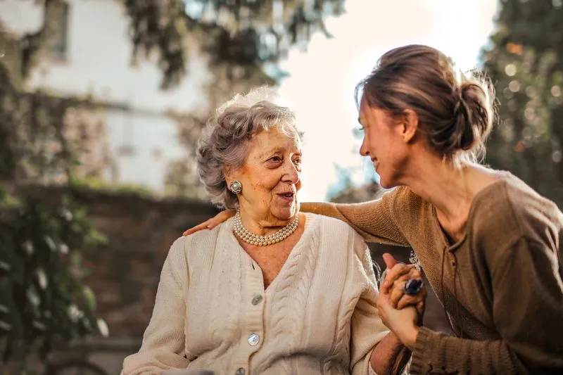 A daughter greeting her elderly mother warmly